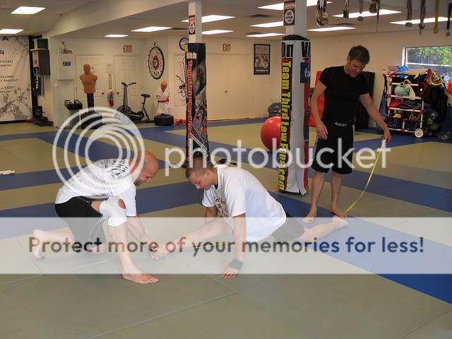 Third Law Yoga Students Measure their Splits as a part of the Naples BJJ, MMA and Yoga School's Yoga Program 